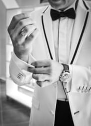 Picture of groom getting ready for the wedding putting on his cuff-lings